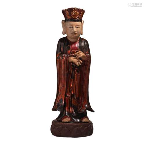 A Vietnamese lacquered wooden figure of a standing monk, on ...