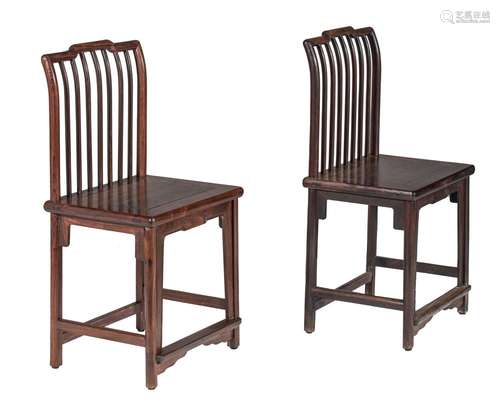 A pair of Chinese hardwood spindle back chairs, Republic per...