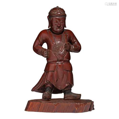 A rare Chinese lacquered wood figure of an Immortal holding ...