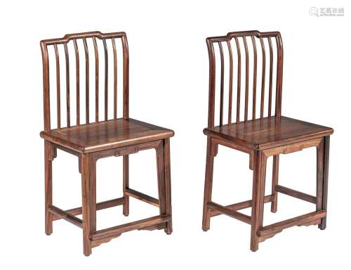 A pair of Chinese hardwood spindle back chairs, Republic per...