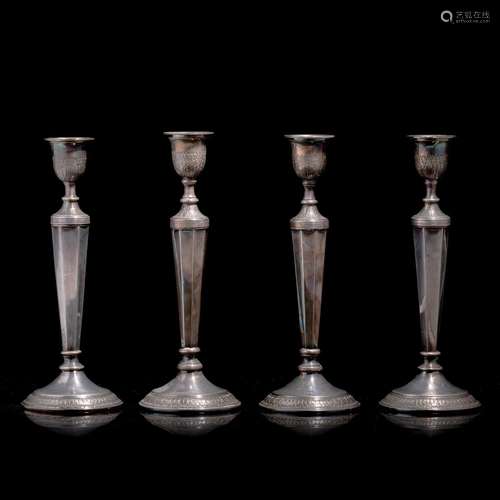 A set of four Neoclassical silver candlesticks by Albert Cha...