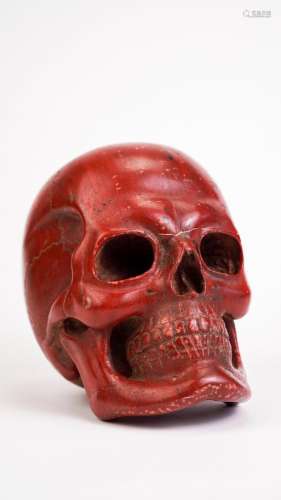 Skull in ancient red marble. Antique marble sculpture.