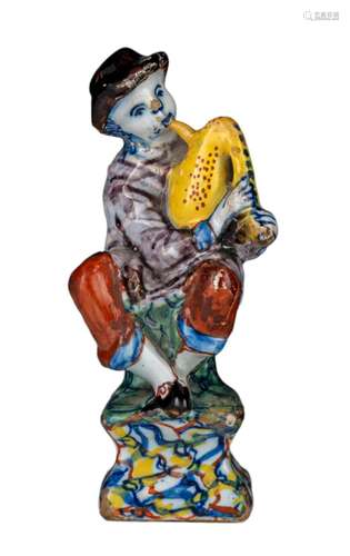 An 18thC Dutch Delft polychrome decorated figurine of a bagp...