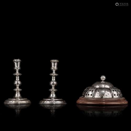 A pair of English sterling silver candlesticks and a matchin...