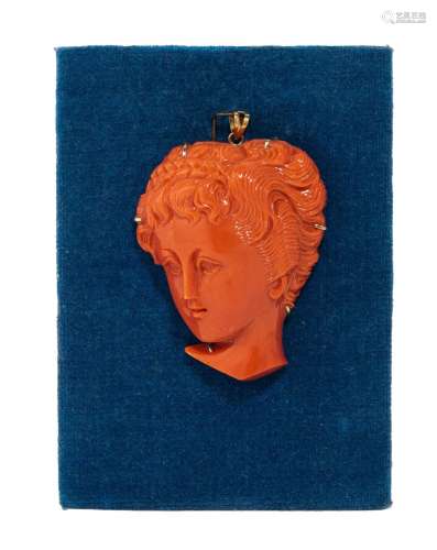 A carved red coral pendant of a female head, with 14ct gold ...