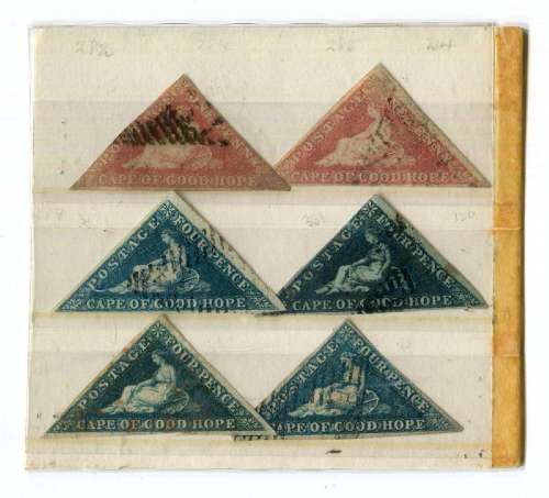 A collection of world stamps on old album pages and in a fai...