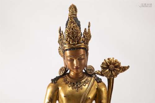 A BRONZE-GILT STANDING FIGURE OF BUDDHA