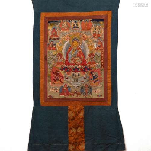 AN EMBROIDERED THANGKA OF SEATED PADMASAMBHAVA