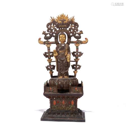 A PARTLY GILT STANDING SHAKYAMUNI