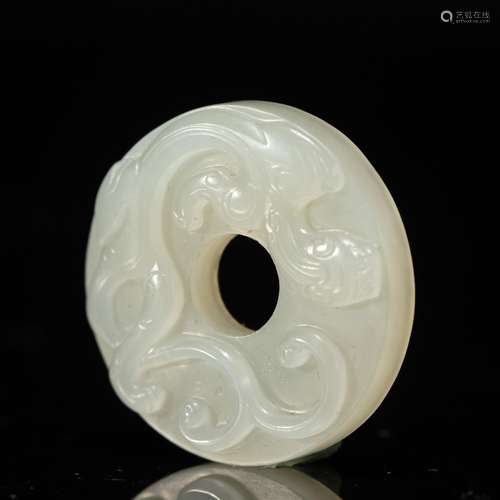 A CARVED JADE DISC PENDANT