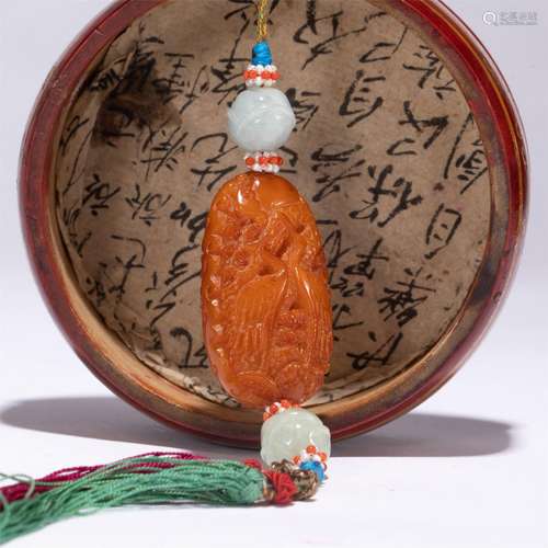 A CHINESE CARVED AMBER PENDANT