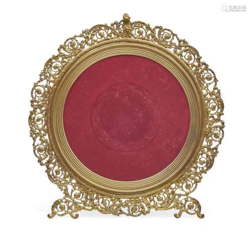 A RENAISSANCE REVIVAL STYLE GILT BRONZE CIRCULAR FRAME