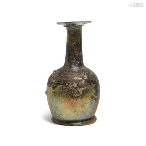 A ROMAN GREEN GLASS BOTTLE WITH THREADED DECORATION