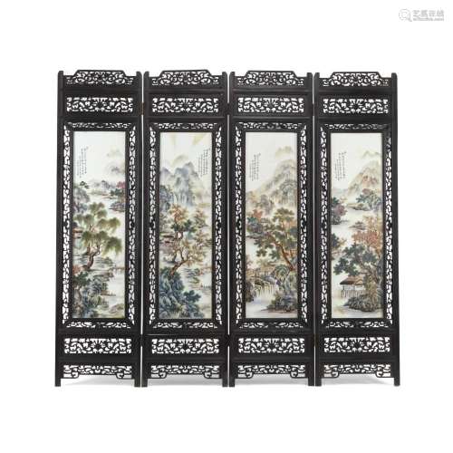 A CHINESE PORCELAIN AND CARVED WOOD FOUR-PANEL SCREEN
