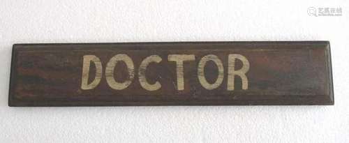 Wooden name plate " Doctor " .