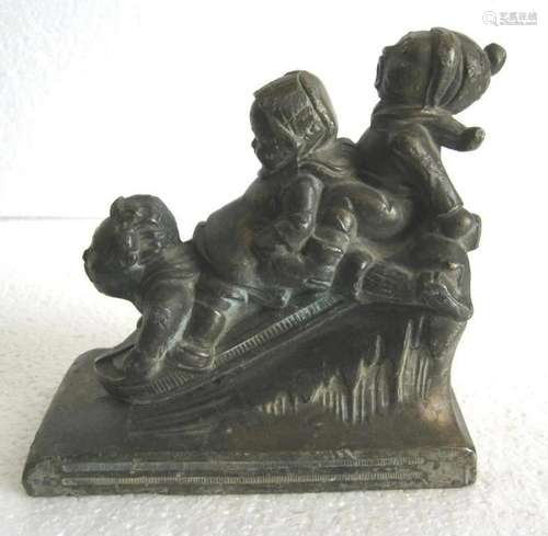 Bronze children on snow sledge