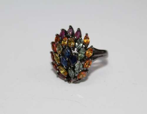 A multi coloured sapphire and ruby 925 stamped cocktail ring...