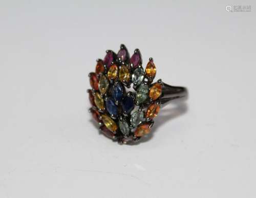 A multi coloured sapphire and ruby 925 stamped cocktail ring...