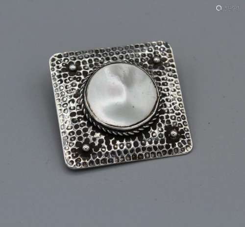 An Arts and Crafts brooch in a square shape and set with a m...