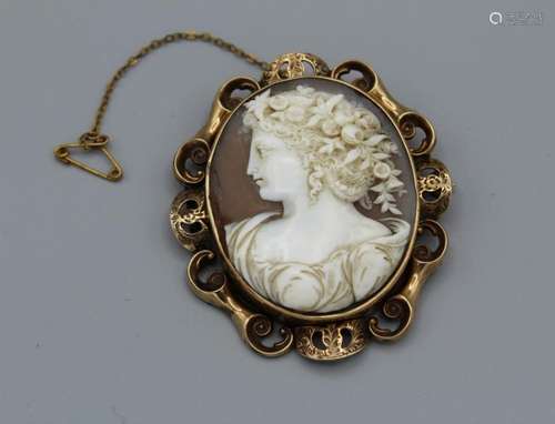 A shell cameo brooch, with a substantial scrollwork mount in...