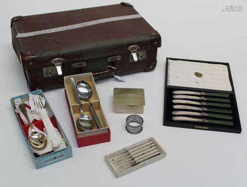 A small early 20th century suitcase containing stainless ste...