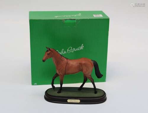 A Beswick style figure of Red Rum raised on a plinth with bo...