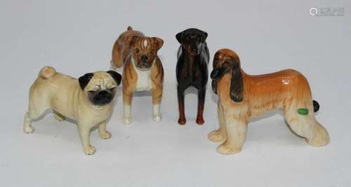 A group of four Beswick figures, a Boxer, H14cm, a Doberman,...