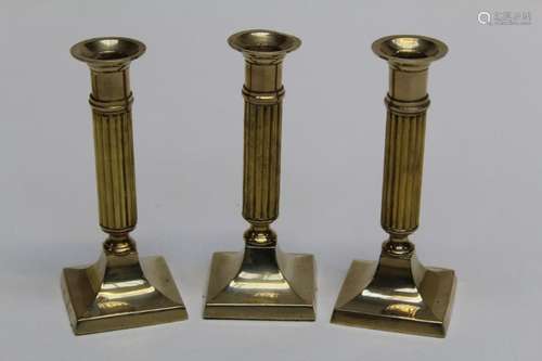 A trio of columnar brass candlesticks made in India