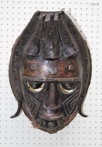 A 20th century cast bronze African tribal mask with woven gr...