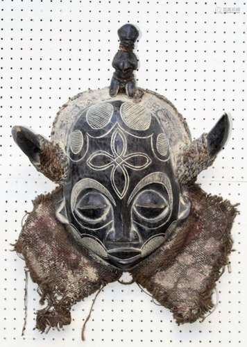 A 20th century carved wood African Tribal mask, with horns, ...