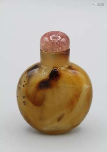 Snuff Bottle. Chalcedony of compressed ovoid form resting on...