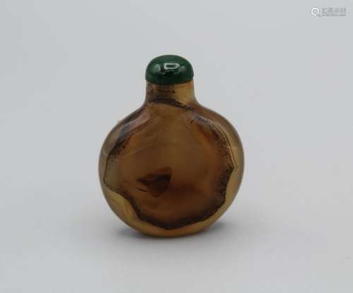 Snuff Bottle. Chalcedony of compressed round form resting on...