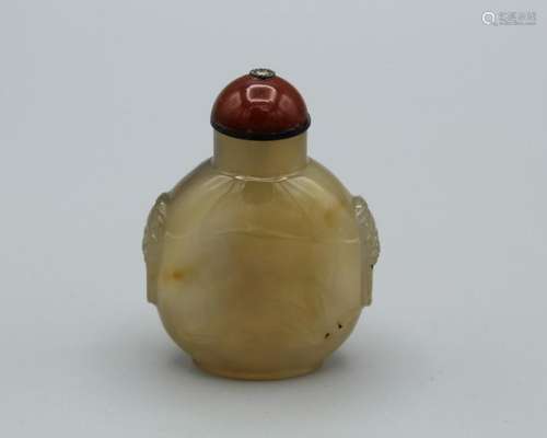 Snuff Bottle. Chalcedony of compressed ovoid shape, raised o...