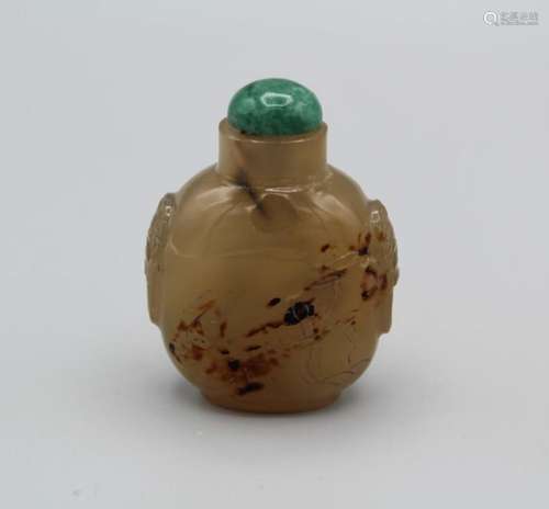 Snuff Bottle. Chalcedony of bulbous ovoid form, with a raise...