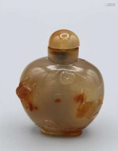 Snuff Bottle. Chalcedony of compressed baluster shape, resti...