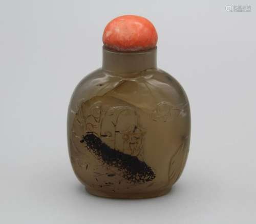 Snuff bottle. Chalcedony of rounded rectangular form on a br...