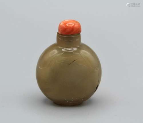 Snuff bottle. Chalcedony of flattened round shape on a small...