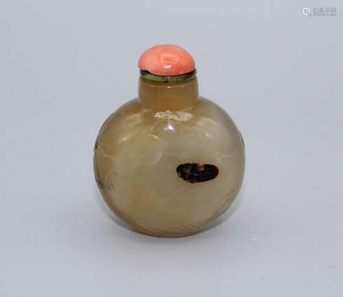 Snuff bottle. Chalcedony of bulbous form resting on a small ...