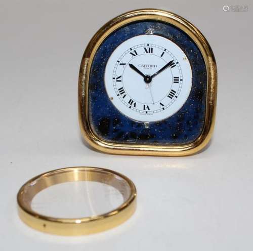 Cartier, Paris, a gilt metal and simulated lapis lazuli case...