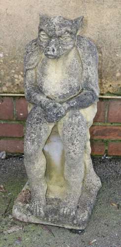 A nicely weathered reconstituted stone model of a gargoyle, ...