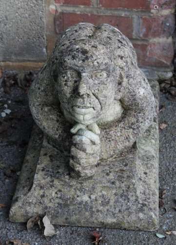 A reconstituted stone model of a kneeling goblin type creatu...