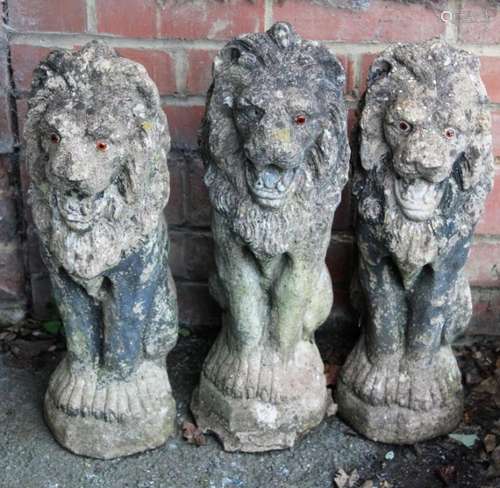 Three nicely weathered reconstituted stone lions, each model...