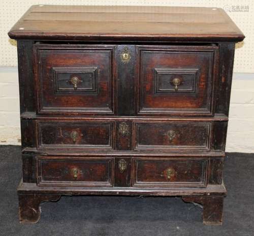 A 17th century oak chest, the rectangular planked top over s...