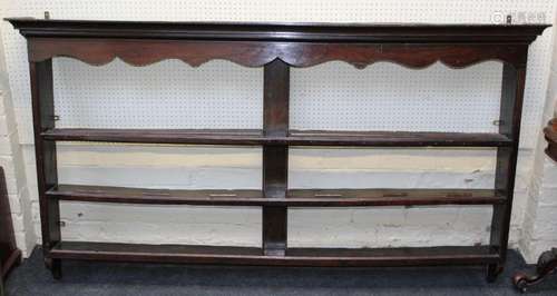 A mid 18th century oak delft rack, the moulded cornice over ...