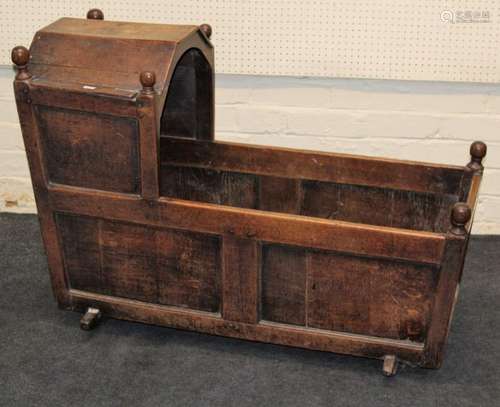 A 19th century oak rocking cradle, of pegged and panel const...