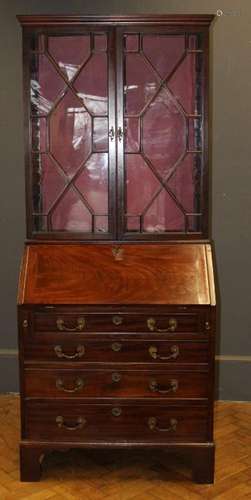 A late George III walnut small bureau having four long drawe...