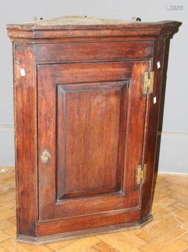 A George III mahogany wall mounting corner cupboard, the mou...