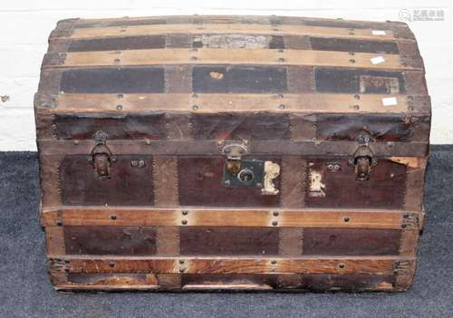 An Edwardian wood banded dome top cabin trunk with twin side...