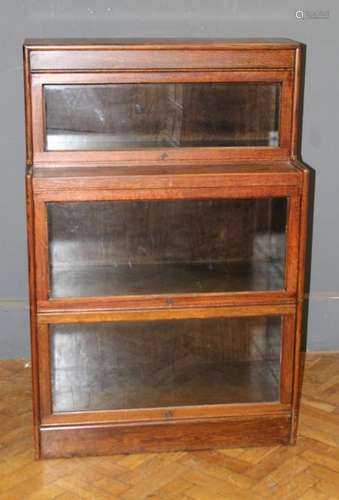 An oak Globe Wernicke type low bookcase of staggered outline...