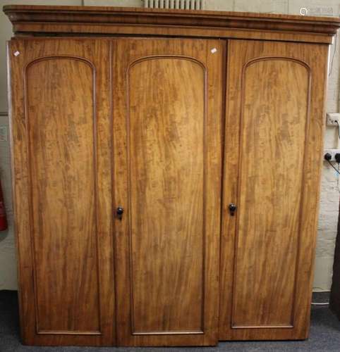 A Victorian mahogany triple wardrobe / press, the moulded co...